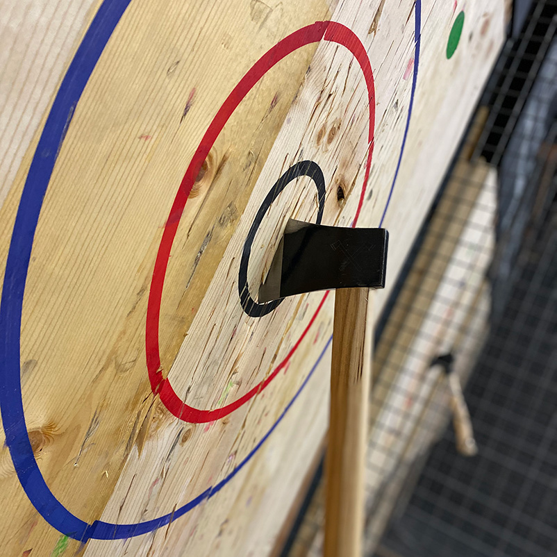 Axe stuck in the bullseye at Axe Thro Co